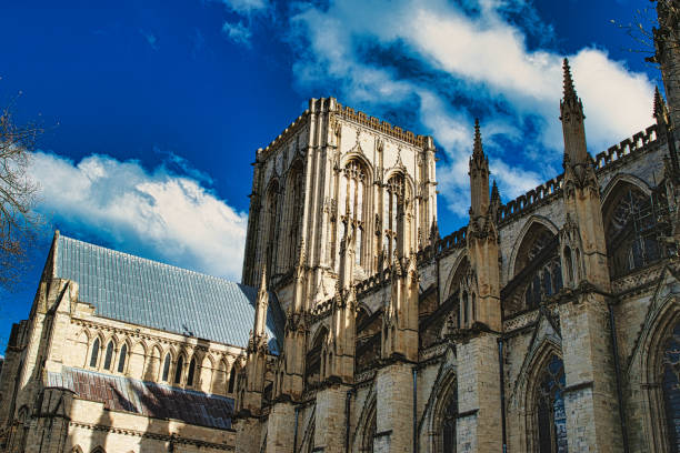 istock Majestic Gothic cathedral against a blue sky with fluffy clouds, showcasing intricate architecture and historical grandeur in York, North Yorkshire, England. 2167066685