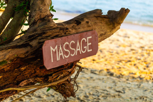 istock Old signboard with the inscription, massage, on a tropical beach 2167067159