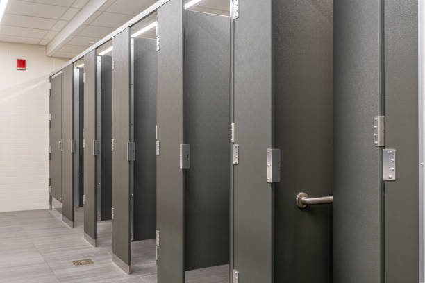 istock Public restroom with gray and white tile stalls, sink and lavatories 2167069588