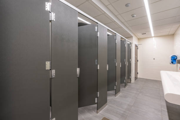 istock Public restroom with gray and white tile stalls, sink and lavatories 2167069599