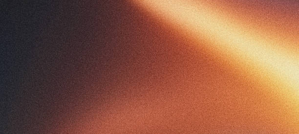 istock Grainy gradient background, orange brown golden yellow glowing light dark noisy texture banner poster backdrop design 2167069922