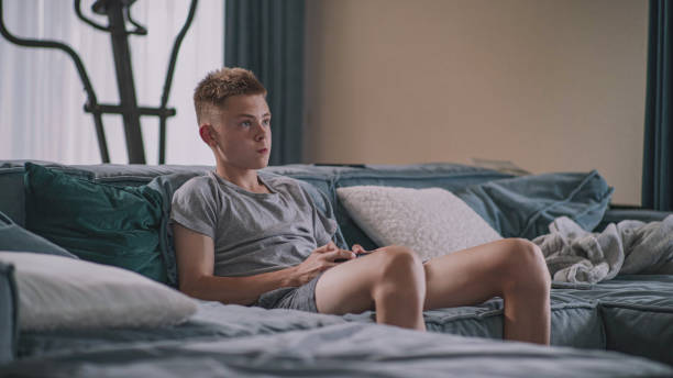 istock Focused teen boy plays online video game on console at home using controller 2167071312