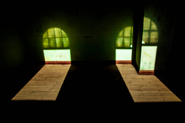 Kolmanskop, a ghost town near the Atlantic coast town of Luderitz, Namibia in southwestern Africa.  Kolmanskop was an active diamond mining community founded in about 1912 but by the mid 1920's the price of diamonds dropped, which essentially led to the demise of the town.  This image is taken from the inside of a building with light coming through windows.