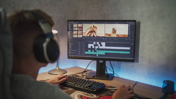 istock Teenage boy edits video or movie using video editing software on PC 2167075487