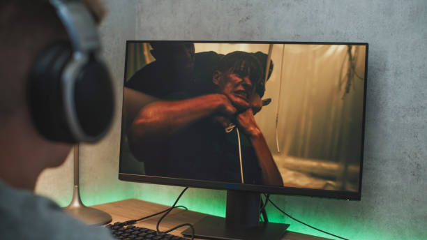 istock Young boy watches online thriller movie on personal computer 2167076366