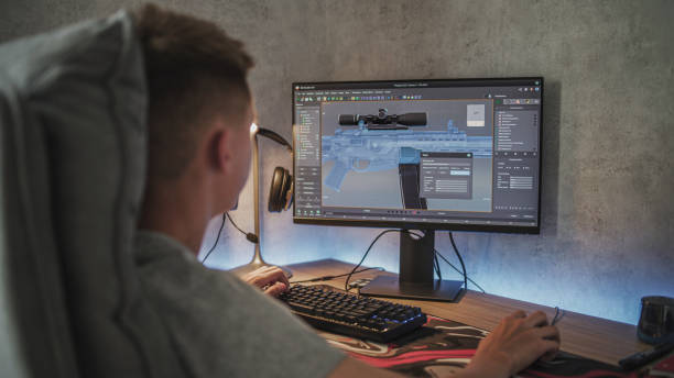 istock Caucasian teenager creates 3D model of sniper rifle using computer 2167076574