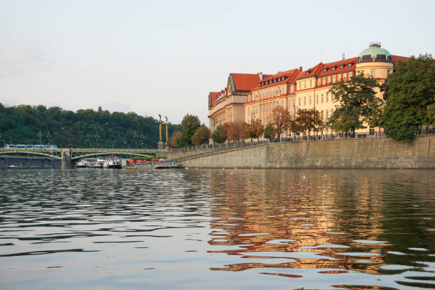 View of buildings by river against clear sky