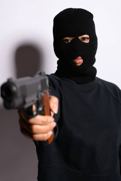 istock latin woman pointing a gun 2167078250
