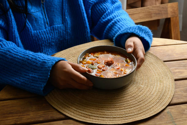person eating lentil stew