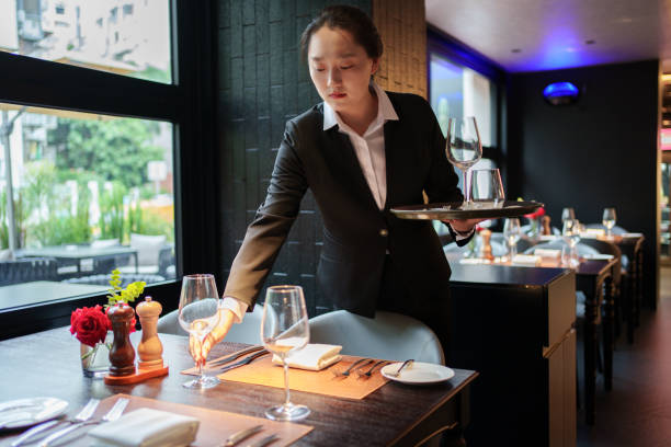 istock Waiter placing wine glasses 2167080704