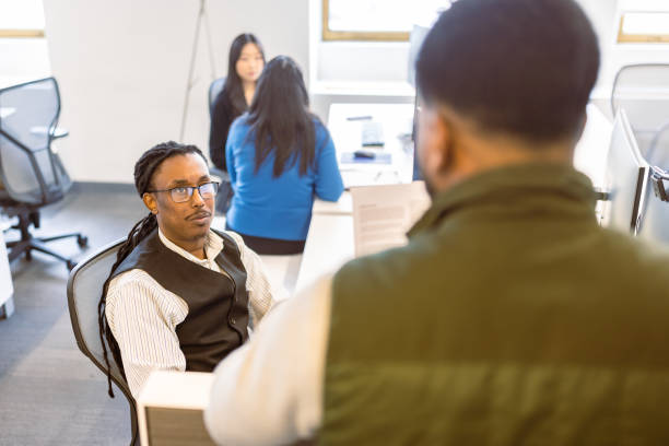 istock Office Colleagues in Discussion During Daytime 2167083829