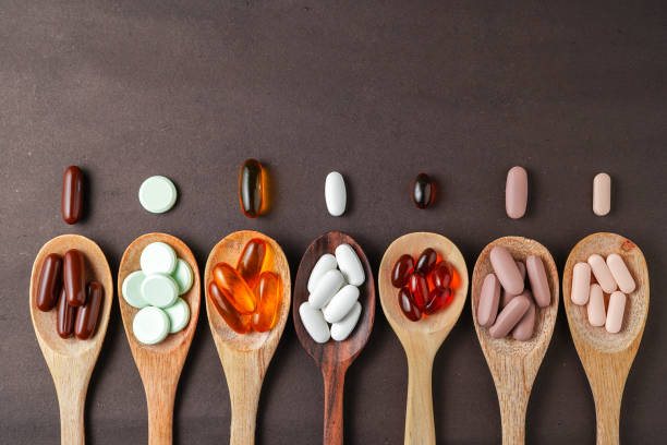 istock Assorted different Pills, supplement vitamin, 

in a wooden spoon on a dark background 2167084887
