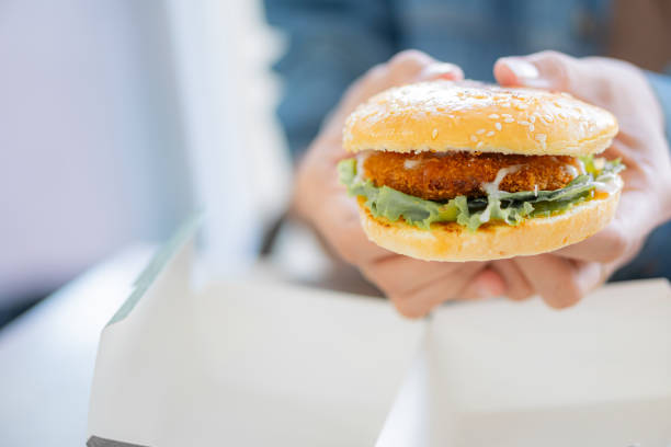 istock Crispy Burger in Hand with Sesame Seed Bun 2167086827