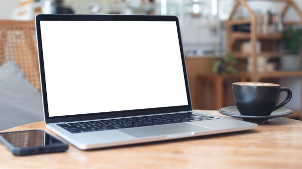 istock Mockup, laptop blank screen on wood table with coffee cafe background, template for your text advertisement 2167092423
