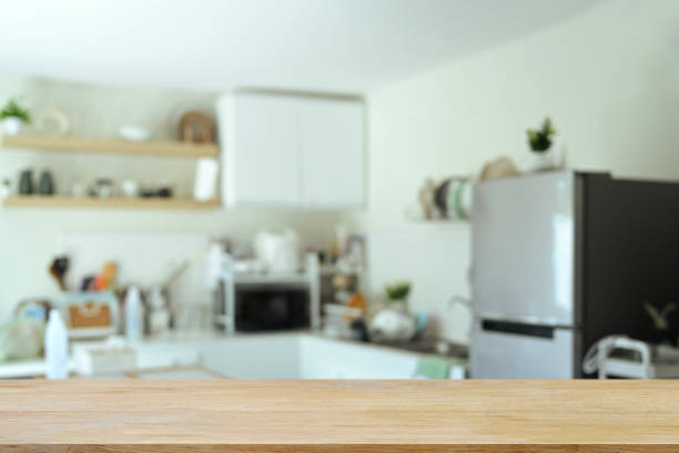 istock Empty wood table with blurred kitchen room in background, space text or showcasing products 2167094632