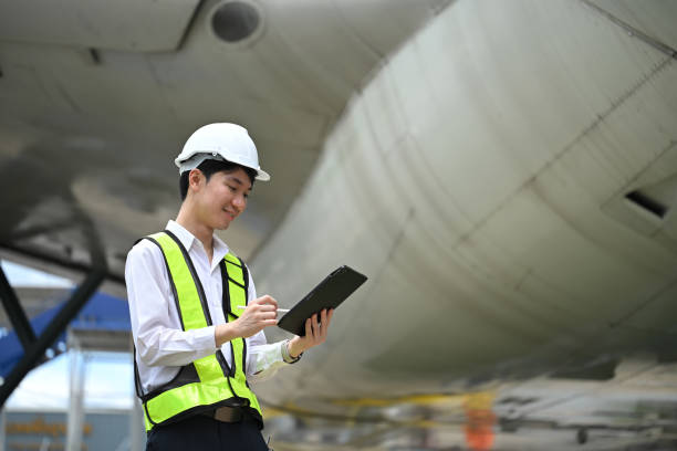 istock Male engineer or aviation technician using digital tablet in front of large aircraft engine 2167094878