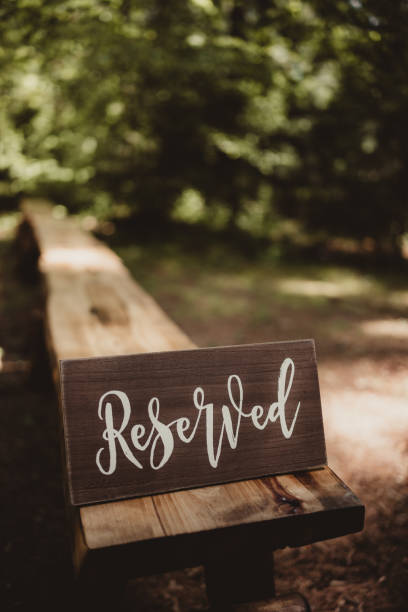 istock Reserved sign on a wood bench outdoors at a wedding ceremony 2167099640