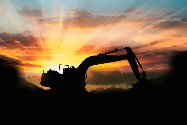 istock Crawler excavators silhouette are digging the soil in the construction site . 2167100164