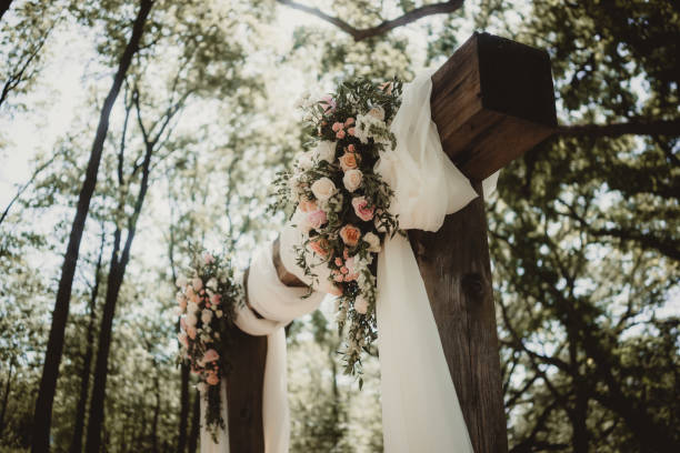 Romantic wedding trellis outdoors in the forest with boho decoration