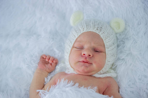 istock cute little girl baby sleeping with teddy bear. 2167107607