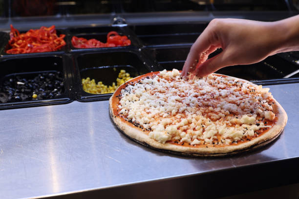 Female chef is preparing pizza