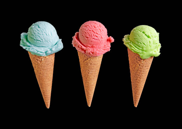 istock Three ice creams in a cone: berry, pistachio and mint on a black background 2167109023