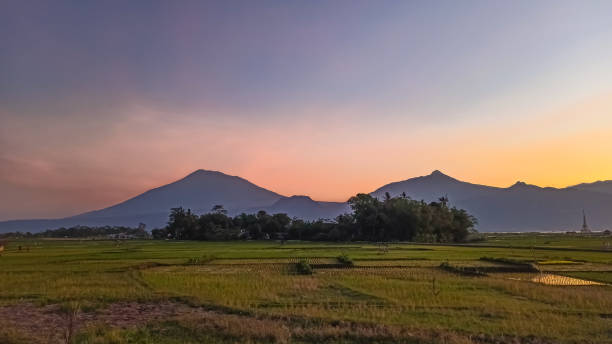 istock Serene Sunset Over Majestic Mountain Landscape and Lush Green Fields 2167110284