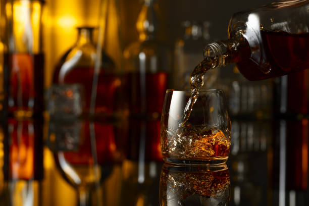 istock Pouring whiskey from a bottle into a glass. 2167114812