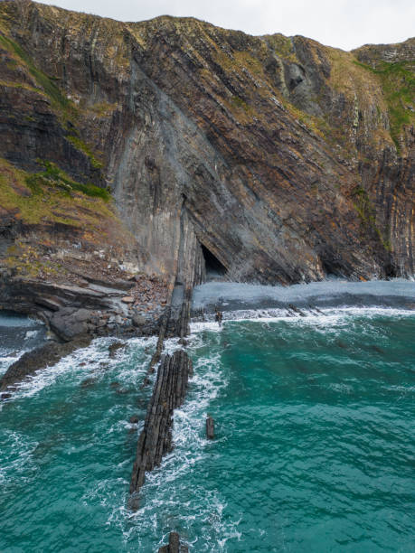 istock Cave at Hartland Quay beach with rock pattern aerial view 2167116910