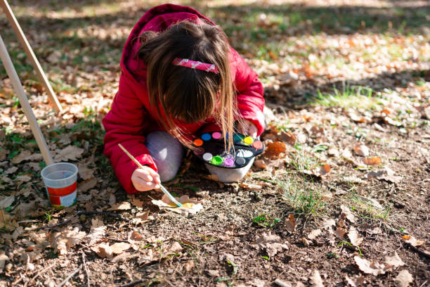 istock Girl having fun painting autumn leaf 2167117569