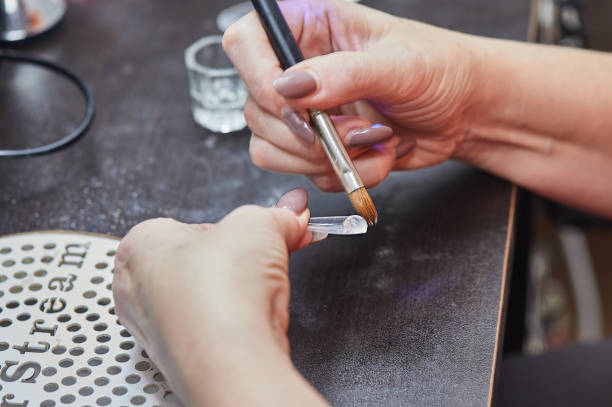 istock Nail Technician Applying Gel to Nail 2167118205