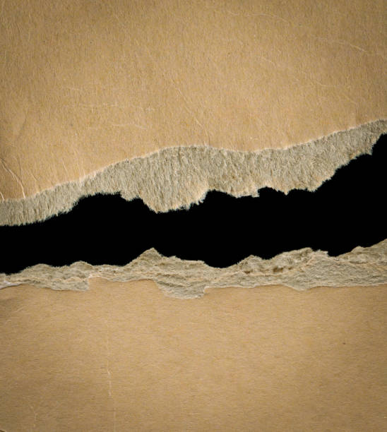 istock Cut or torn paper with brown background textured 2167120604