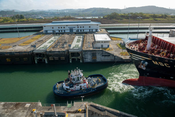 Panama City, Panama - 04,14,2023 - Big container ship passes through the new Cocoli locks in the old Miraflores Locks area as it transits the Panama Canal - stock photo