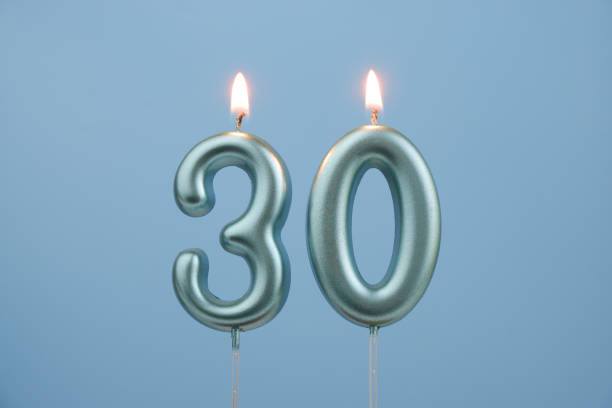 istock Blue birthday candles on blue background, number 30 2167122882