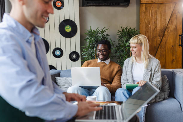 istock Cheerful diverse young coworkers chatting in modern co-working space 2167122949