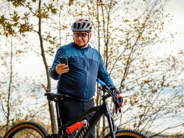 istock A cyclist on an electric mountain bike using a mobile phone 2167124526