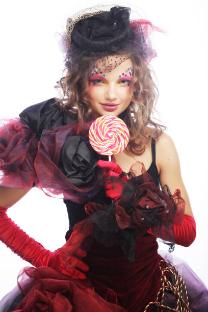 istock Girl with with creative make-up holds lollipop. 2167125148