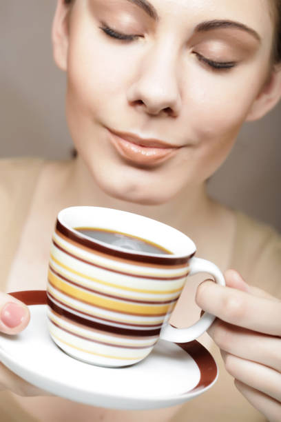 istock young pretty woman drinking coffee 2167125165
