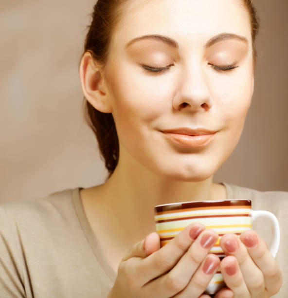 istock woman with coffee and cookies 2167125481