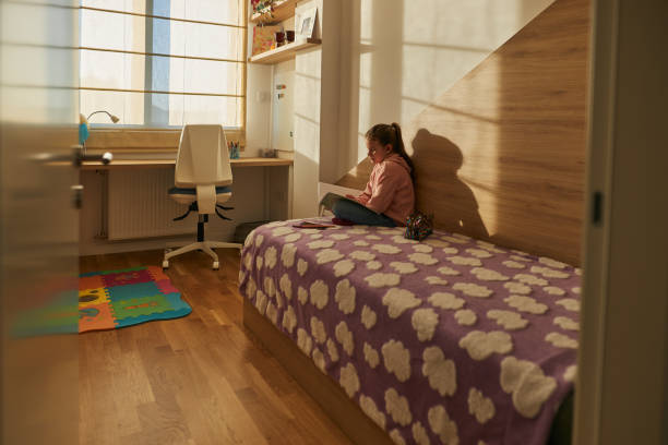 istock Schoolgirl studying at home 2167126565