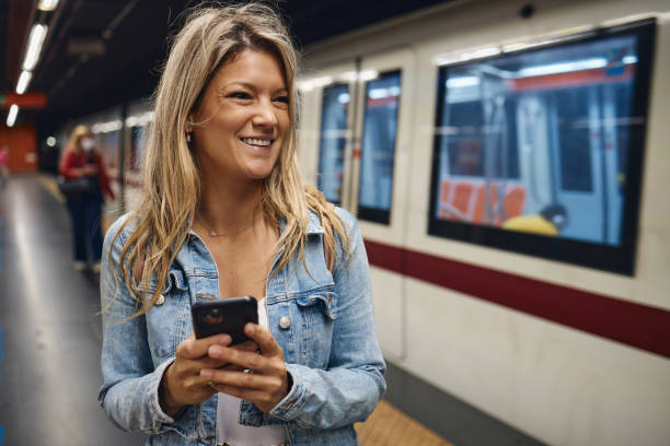 istock Young female tourist using a phone while waiting for a train 2167126980