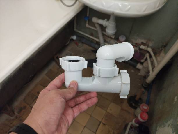 istock Man holds a bathtub siphon in his hand 2167127279