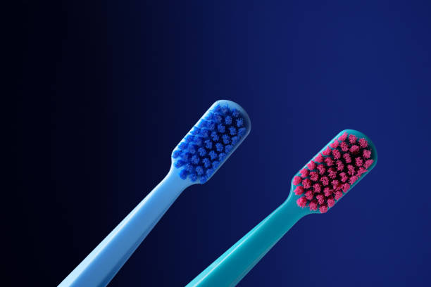 istock Two bright plastic toothbrushes on a dark blue background. 2167131872
