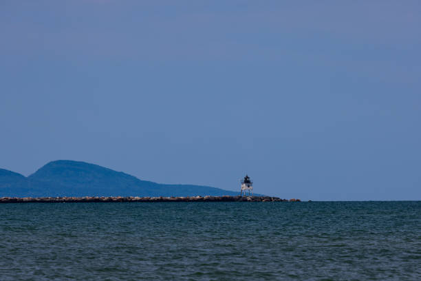 A seascape featuring an old breakwater lighthouse along Great Lake Superior.