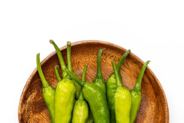 Green chili pepper in an enamel bowl