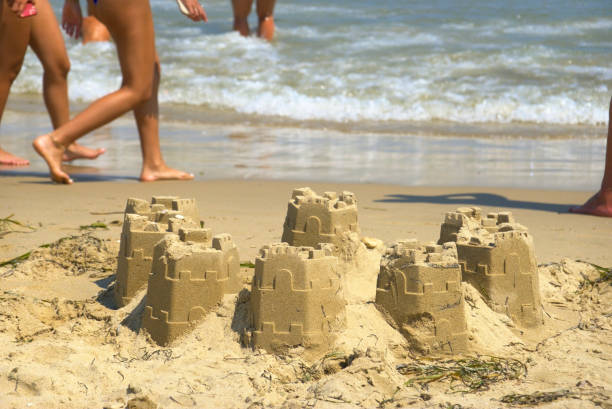 Sand castle on sandy beach in sea shore at sunset time , summer holiday vacation at tropical island.