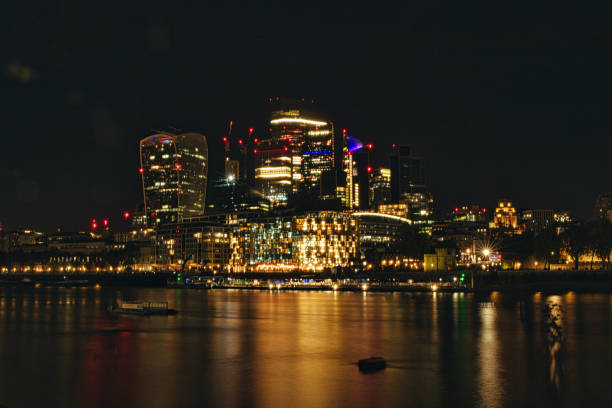 istock Night cityscape with illuminated buildings reflected on water surface. 2167137028