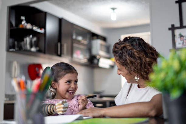 istock Mom helping her daughter to do homework. 2167137748