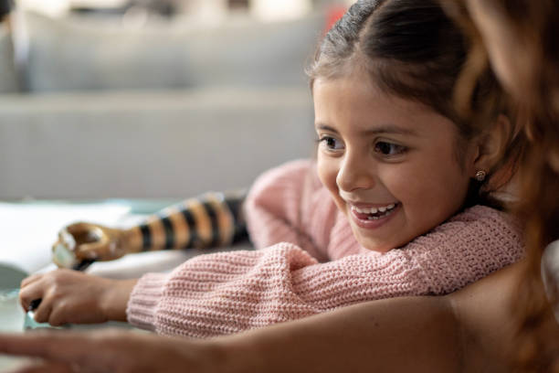 istock Mom helping her daughter to do homework. 2167137749