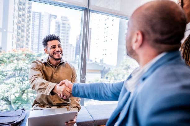 istock Young businessman greeting coworker at office 2167140460